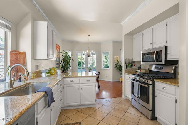 28802 Raintree Ln, Saugus, CA 91390 - kitchen featuring appliances with stainless steel finishes, a chandelier, light tile patterned floors, a peninsula, and white cabinets