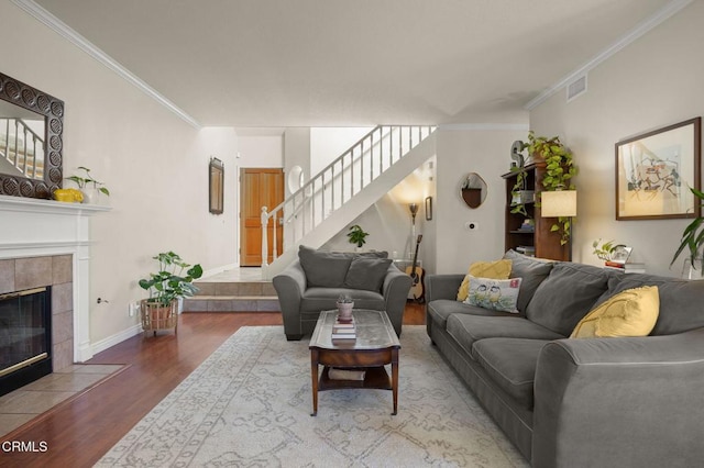 28802 Raintree Ln, Saugus, CA 91390 - living area featuring wood finished floors, stairs, ornamental molding, and a fireplace