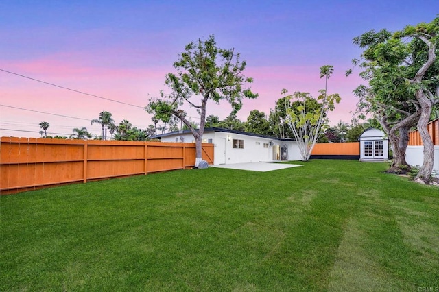 709 Puebla St, Encinitas, CA 92024 - yard at dusk with a fenced backyard, a patio area, and a shed