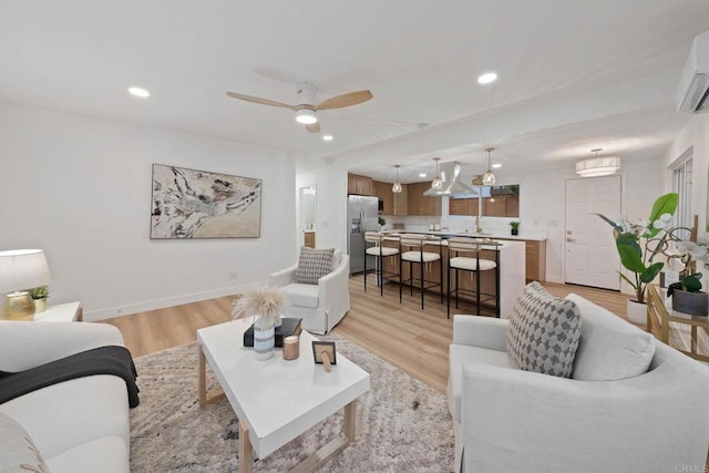709 Puebla St, Encinitas, CA 92024 - living room with recessed lighting, light wood-style flooring, a ceiling fan, and a wall mounted air conditioner