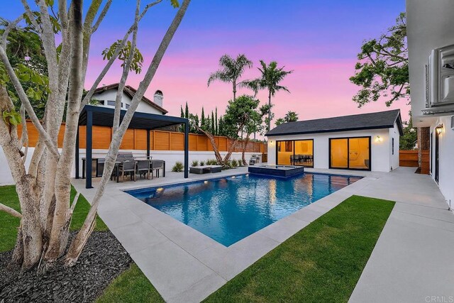 709 Puebla St, Encinitas, CA 92024 - pool at dusk with a storage structure, an outdoor structure, a fenced backyard, a pool with connected hot tub, and a patio area