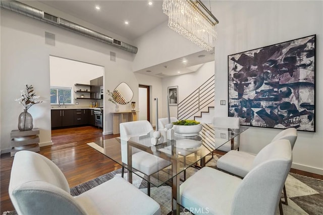 2531 N Commonwealth Ave, Los Angeles, CA 90027 - dining space featuring stairway, a high ceiling, dark wood finished floors, a chandelier, and recessed lighting
