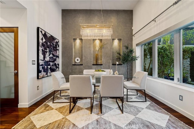 2531 N Commonwealth Ave, Los Angeles, CA 90027 - dining room featuring wood finished floors, a high ceiling, and a chandelier