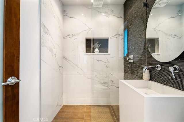 2531 N Commonwealth Ave, Los Angeles, CA 90027 - bathroom featuring tile walls, a marble finish shower, and vanity