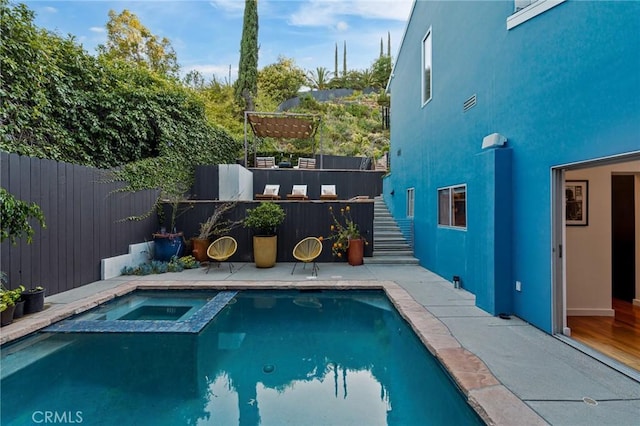 2531 N Commonwealth Ave, Los Angeles, CA 90027 - view of pool with a fenced backyard, a pool with connected hot tub, and stairway