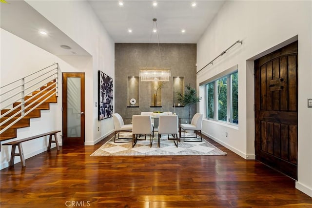 2531 N Commonwealth Ave, Los Angeles, CA 90027 - dining space featuring a high ceiling, stairs, wood finished floors, and recessed lighting