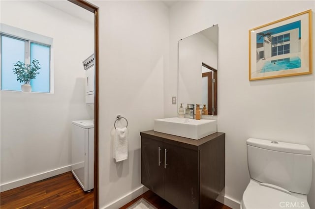 2531 N Commonwealth Ave, Los Angeles, CA 90027 - bathroom featuring vanity, wood finished floors, and stacked washing machine and dryer