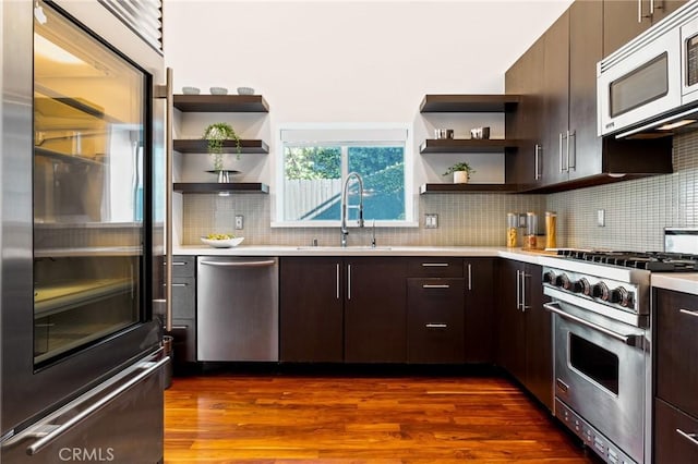 2531 N Commonwealth Ave, Los Angeles, CA 90027 - kitchen featuring premium appliances, open shelves, light countertops, dark brown cabinets, and tasteful backsplash