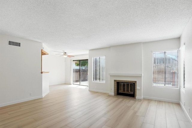 8373 Suntree Pl, San Diego, CA 92119 - unfurnished living room featuring a ceiling fan, a fireplace with flush hearth, a textured ceiling, and light wood finished floors