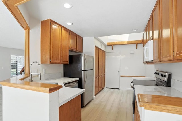 8373 Suntree Pl, San Diego, CA 92119 - kitchen with appliances with stainless steel finishes, a peninsula, light wood-type flooring, recessed lighting, and brown cabinets