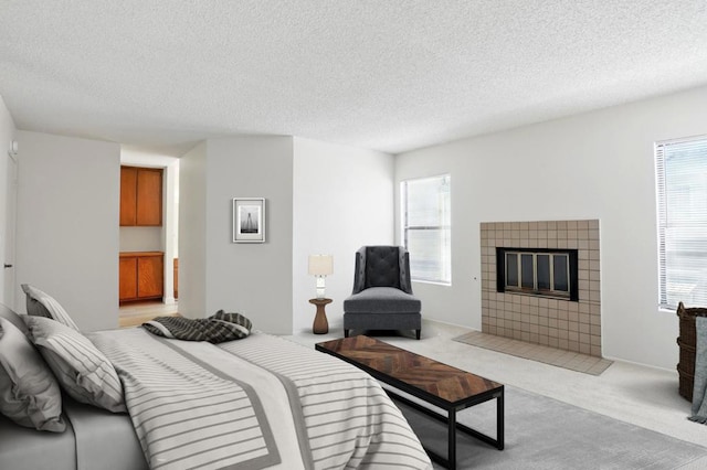 8373 Suntree Pl, San Diego, CA 92119 - bedroom featuring a textured ceiling, a fireplace, and light colored carpet