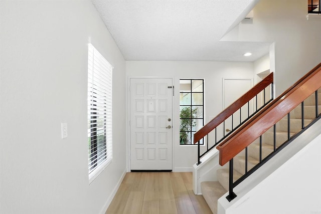 8373 Suntree Pl, San Diego, CA 92119 - foyer entrance featuring wood finished floors, stairs, and recessed lighting