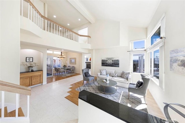 4 Narbonne, Laguna Niguel, CA 92677 - living room with a chandelier, a towering ceiling, beamed ceiling, arched walkways, and recessed lighting