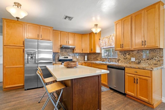 4624 Katherine Place, La Mesa, CA 91942 - kitchen featuring stainless steel appliances, under cabinet range hood, dark wood-type flooring, and decorative backsplash