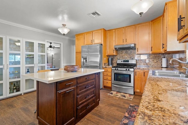 4624 Katherine Place, La Mesa, CA 91942 - kitchen featuring appliances with stainless steel finishes, under cabinet range hood, dark wood-style floors, crown molding, and backsplash