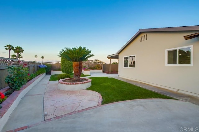 6947 Wallsey Dr, San Diego, CA 92119 - yard at dusk featuring a patio and a fenced backyard