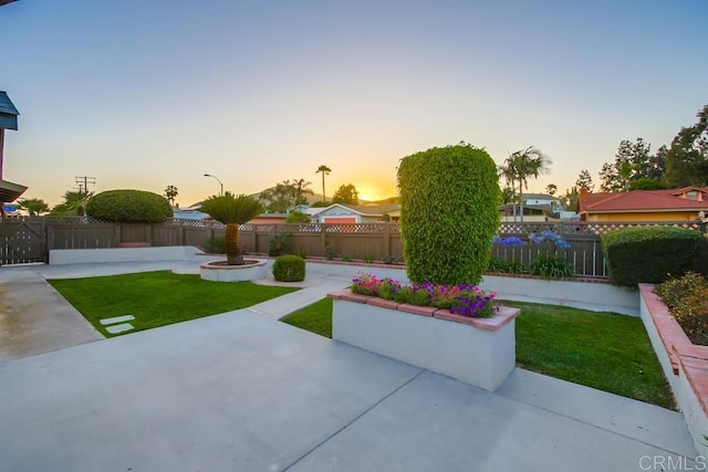 6947 Wallsey Dr, San Diego, CA 92119 - yard at dusk featuring a patio area and a fenced backyard