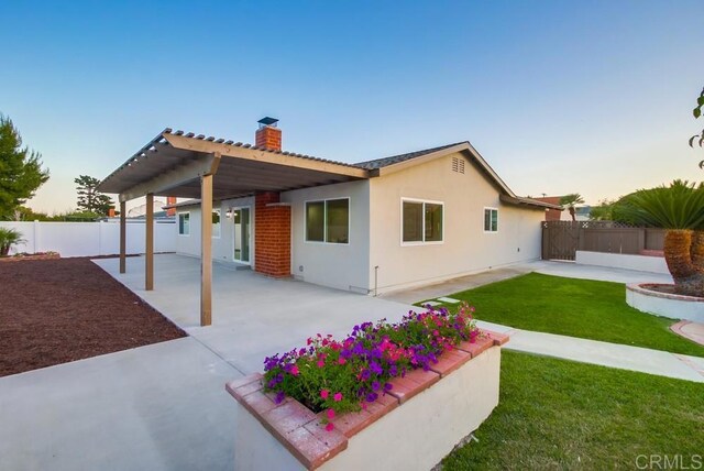 6947 Wallsey Dr, San Diego, CA 92119 - back of house with a chimney, a fenced backyard, a patio area, and stucco siding