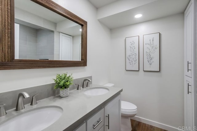 6947 Wallsey Dr, San Diego, CA 92119 - bathroom featuring double vanity, wood finished floors, and recessed lighting