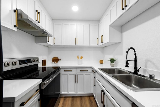 6735 Amherst St, San Diego, CA 92115 - kitchen with electric stove, under cabinet range hood, white cabinets, light countertops, and dark wood finished floors