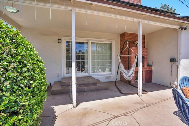 16918 Baltar St, Van Nuys, CA 91406 - view of exterior entry with stucco siding, brick siding, and a patio