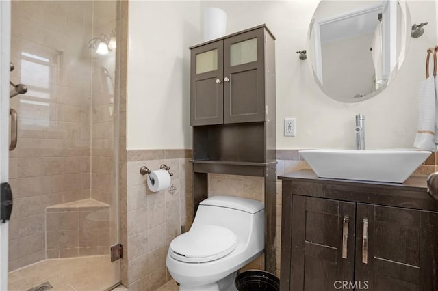 16918 Baltar St, Van Nuys, CA 91406 - bathroom with a shower stall, tile walls, wainscoting, and vanity