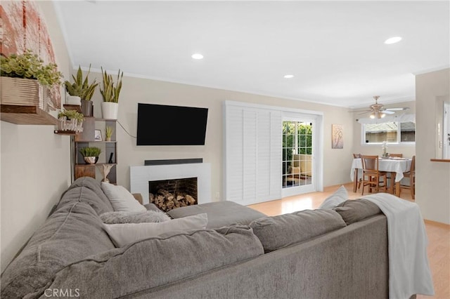 16918 Baltar St, Van Nuys, CA 91406 - living room featuring light wood-style floors, a fireplace, recessed lighting, and a ceiling fan