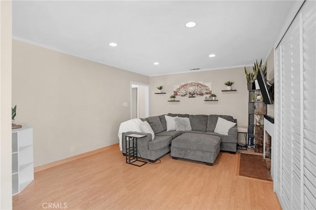 16918 Baltar St, Van Nuys, CA 91406 - living area featuring wood finished floors, recessed lighting, ornamental molding, and a fireplace