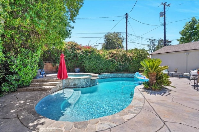 16918 Baltar St, Van Nuys, CA 91406 - view of swimming pool featuring a pool with connected hot tub and a patio area