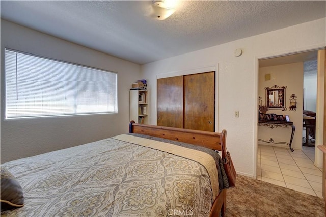 2130 Ocean St, Oceano, CA 93445 - bedroom with light carpet, a textured ceiling, and light tile patterned flooring
