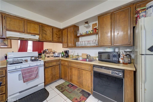 2120 Ocean St, Oceano, CA 93445 - kitchen featuring black appliances, under cabinet range hood, light countertops, and brown cabinets