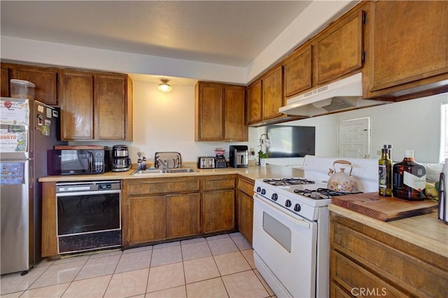 2120 Ocean St, Oceano, CA 93445 - kitchen featuring black appliances, light countertops, brown cabinetry, under cabinet range hood, and light tile patterned flooring