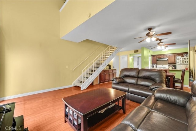 10642 Shoreline Dr Unit 80, Norwalk, CA 90650 - living room with stairs, ceiling fan, and wood finished floors