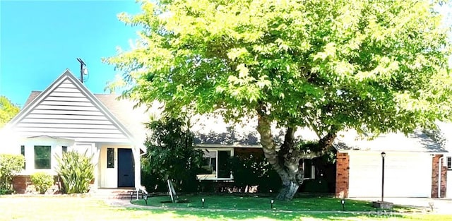 6818 Chisholm Ave, Van Nuys, CA 91406 - view of front of house featuring a front yard, an attached garage, and driveway