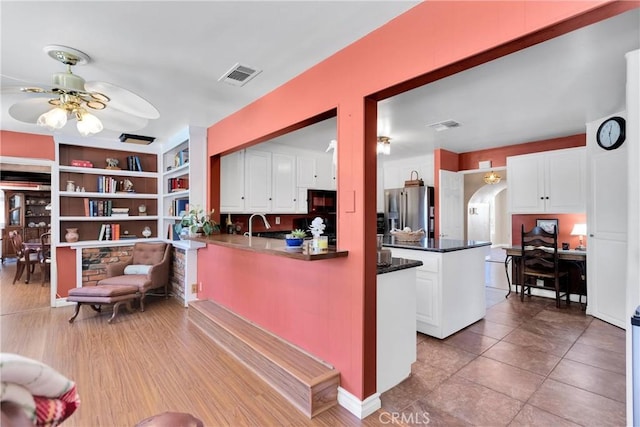 19955 Chickasaw Rd, Apple Valley, CA 92307 - kitchen with high end refrigerator, ceiling fan, white cabinets, and a peninsula