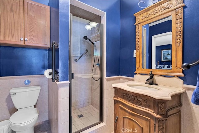 19955 Chickasaw Rd, Apple Valley, CA 92307 - full bathroom featuring vanity, a shower stall, wainscoting, and tile walls