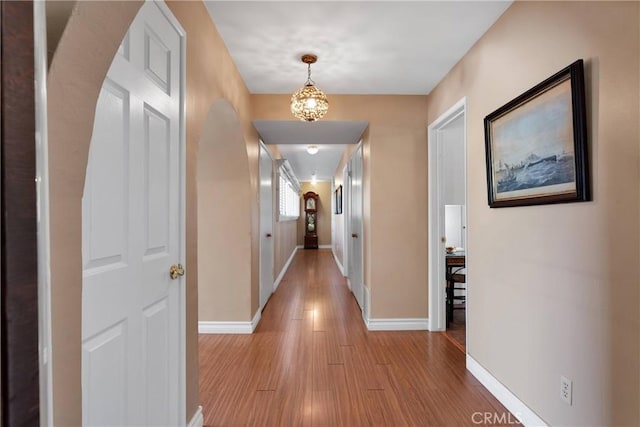 19955 Chickasaw Rd, Apple Valley, CA 92307 - hall with light wood finished floors and a chandelier