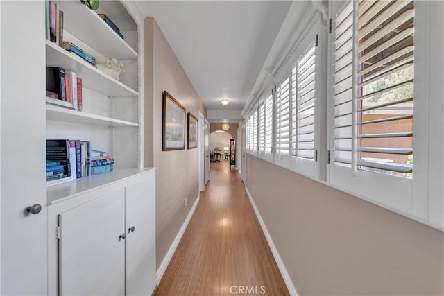 19955 Chickasaw Rd, Apple Valley, CA 92307 - hallway featuring arched walkways and light wood finished floors