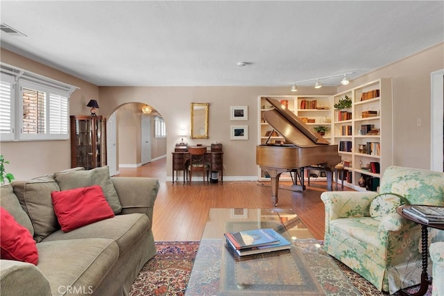 19955 Chickasaw Rd, Apple Valley, CA 92307 - living room featuring arched walkways, healthy amount of natural light, and wood-type flooring