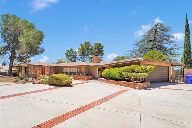 19955 Chickasaw Rd, Apple Valley, CA 92307 - ranch-style house featuring concrete driveway, an attached garage, a chimney, and stucco siding