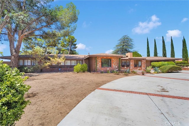 19955 Chickasaw Rd, Apple Valley, CA 92307 - ranch-style home featuring brick siding, concrete driveway, and a chimney
