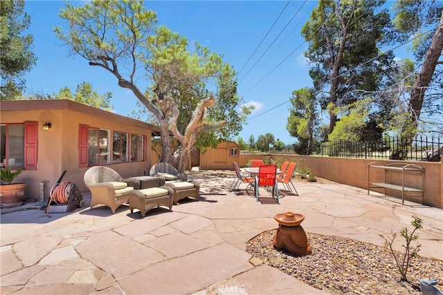 19955 Chickasaw Rd, Apple Valley, CA 92307 - fenced backyard featuring a storage shed, outdoor dining space, and a patio area