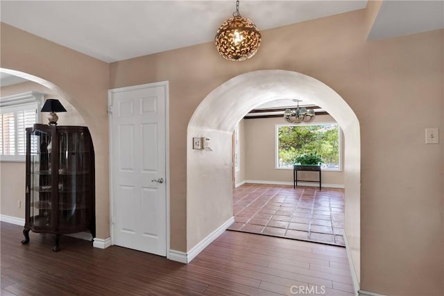 19955 Chickasaw Rd, Apple Valley, CA 92307 - entryway with a chandelier, arched walkways, and wood finished floors