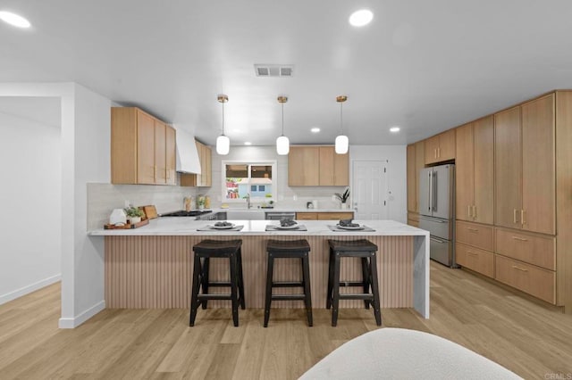 1654 Yale St, Chula Vista, CA 91913 - kitchen featuring high end refrigerator, a peninsula, light wood-type flooring, light countertops, and backsplash