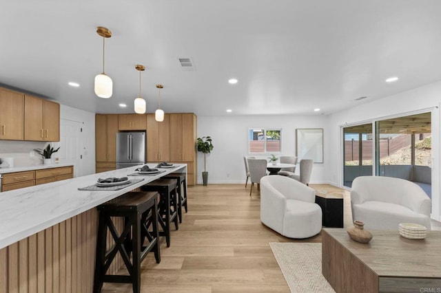 1654 Yale St, Chula Vista, CA 91913 - kitchen featuring freestanding refrigerator, recessed lighting, a kitchen breakfast bar, light wood finished floors, and pendant lighting