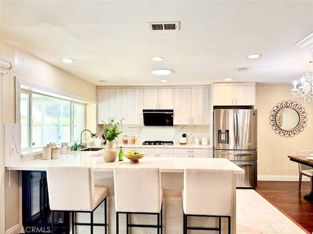 21315 Pinehill Ln, Diamond Bar, CA 91765 - kitchen with stainless steel fridge with ice dispenser, a kitchen breakfast bar, a peninsula, light countertops, and recessed lighting