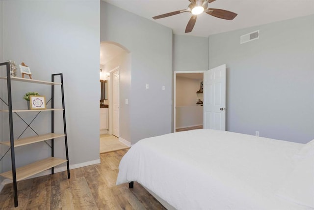 1148 Valdivia Ct, Chula Vista, CA 91910 - bedroom featuring arched walkways, wood finished floors, ceiling fan, and ensuite bath
