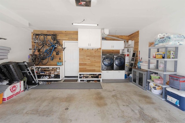 1148 Valdivia Ct, Chula Vista, CA 91910 - garage featuring washing machine and dryer, strapped water heater, wooden walls, a workshop area, and a garage door opener