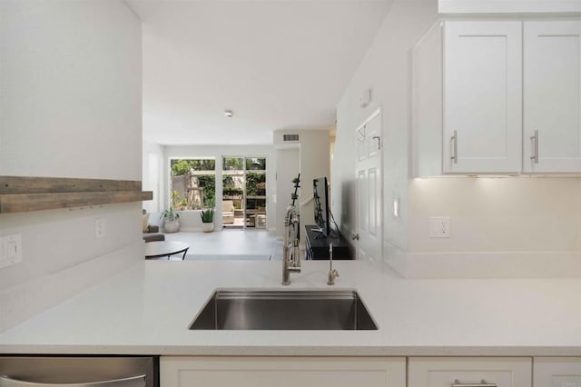 1148 Valdivia Ct, Chula Vista, CA 91910 - kitchen with stainless steel dishwasher, light countertops, and white cabinets