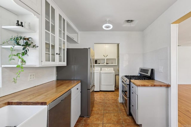 1220 Palomar Ter, Escondido, CA 92027 - kitchen with butcher block countertops, stainless steel appliances, washing machine and clothes dryer, and open shelves
